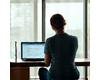 Woman doing quick exercises at her desk, symbolizing fitness for busy professionals
